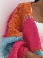 Candy Cloud Cardigan ¨C oversized color block knit in orange, pink, blue, and contrasting tones.